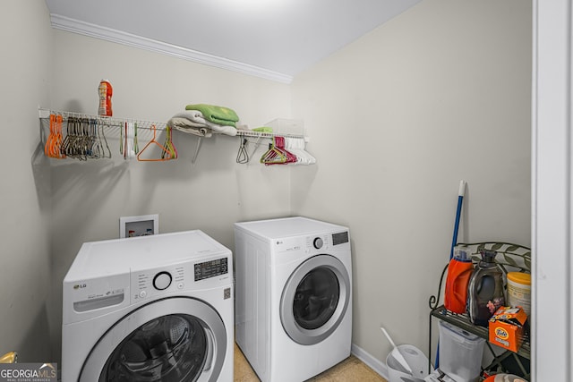 laundry room with ornamental molding and washing machine and clothes dryer