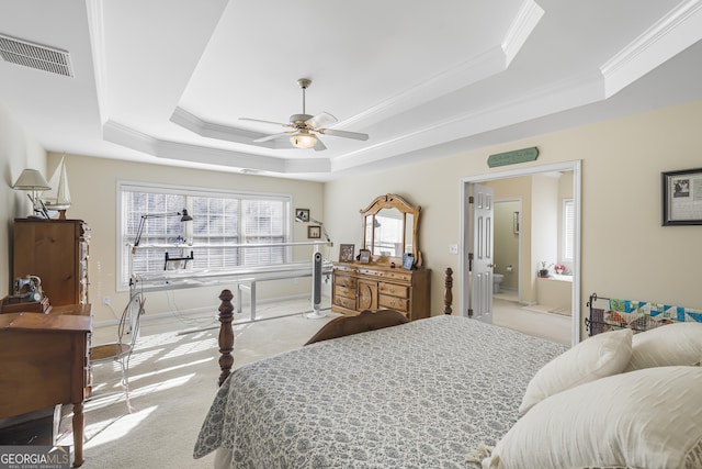 carpeted bedroom with a raised ceiling, crown molding, and ceiling fan