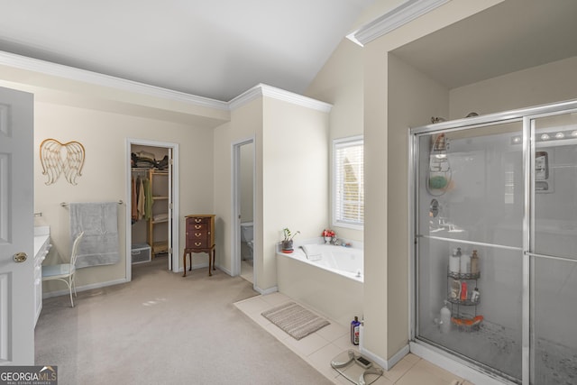 bathroom featuring tile patterned flooring, shower with separate bathtub, lofted ceiling, and toilet