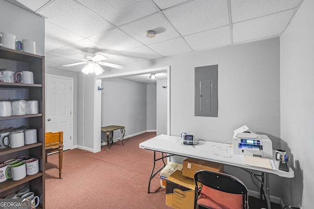 office area with a paneled ceiling, electric panel, ceiling fan, and carpet flooring