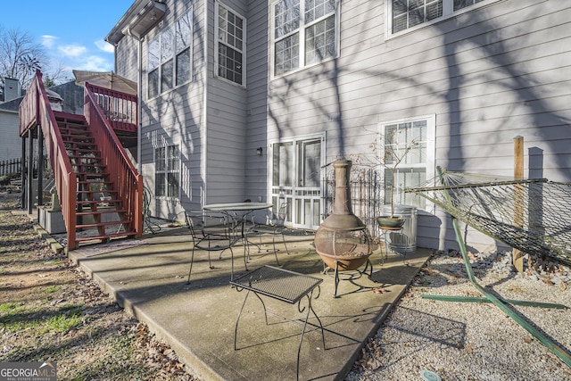 view of patio featuring a wooden deck and an outdoor fire pit