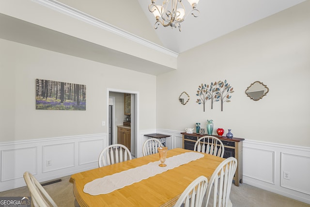 dining room featuring high vaulted ceiling, light colored carpet, and a chandelier