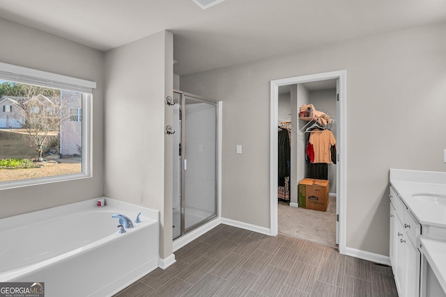 bathroom featuring vanity and separate shower and tub