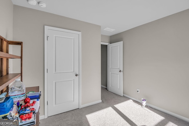 bedroom featuring light carpet