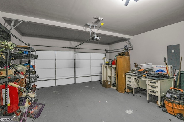 garage with a garage door opener and electric panel