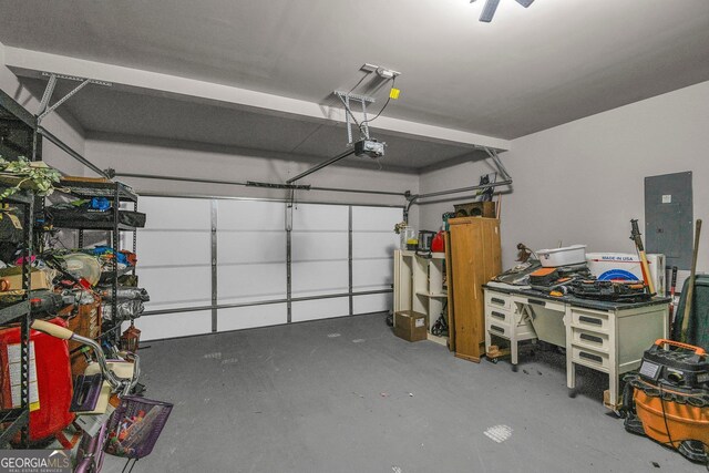 garage with a garage door opener and electric panel