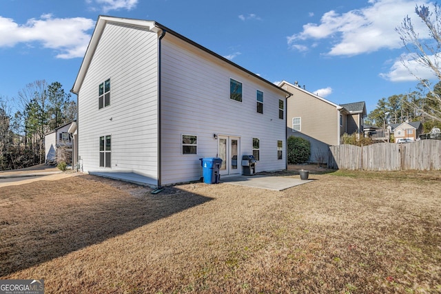 rear view of house with a lawn and a patio area