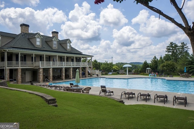 view of pool with a yard and a patio area