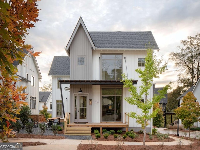 view of front of property featuring roof with shingles