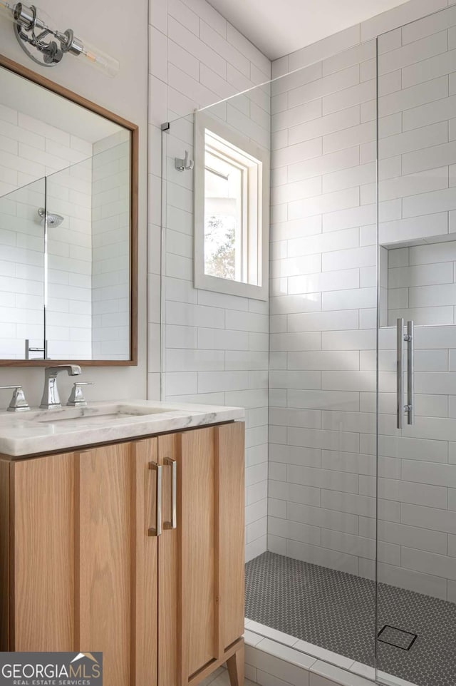 full bath featuring a stall shower and vanity