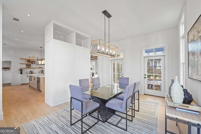 dining area featuring french doors, recessed lighting, visible vents, light wood-style flooring, and a chandelier