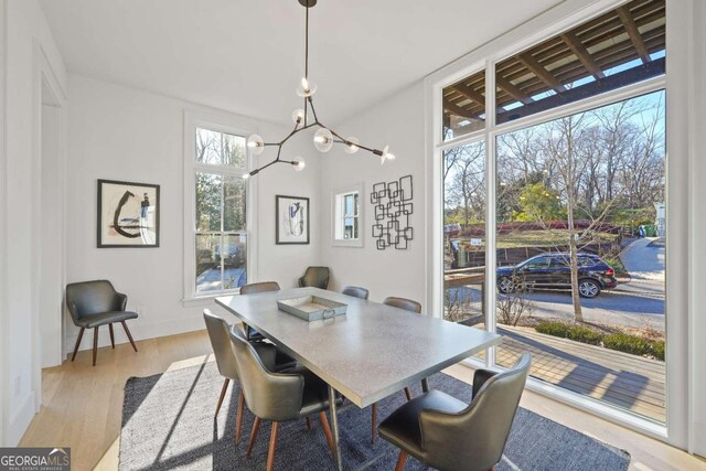 dining area featuring a chandelier and light hardwood / wood-style flooring