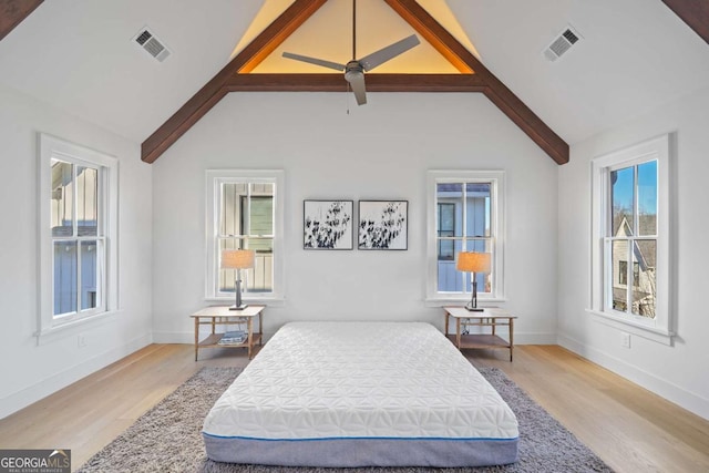 bedroom featuring ceiling fan, lofted ceiling with beams, and light hardwood / wood-style flooring