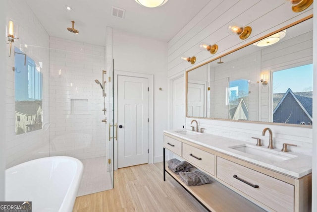 bathroom featuring vanity, independent shower and bath, and hardwood / wood-style floors