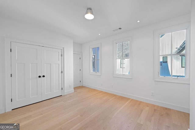 unfurnished bedroom featuring light wood-type flooring