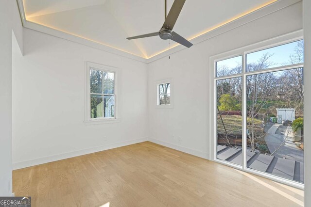 spare room featuring ceiling fan, light hardwood / wood-style flooring, and lofted ceiling