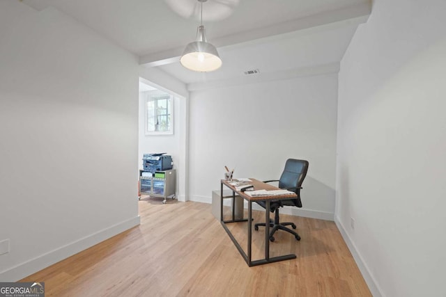 office with light wood-type flooring and beamed ceiling