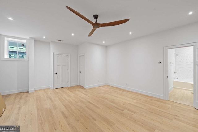 spare room featuring ceiling fan and light hardwood / wood-style floors