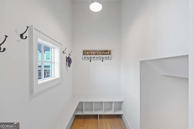 mudroom featuring wood finished floors and baseboards