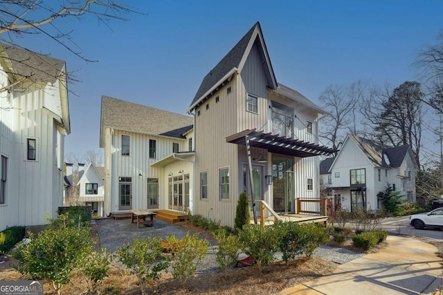 exterior space featuring board and batten siding, a residential view, a patio area, and a balcony