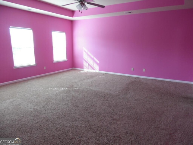 spare room featuring ceiling fan and carpet flooring