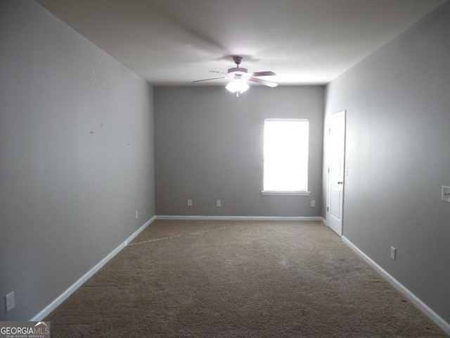 unfurnished room featuring ceiling fan and carpet