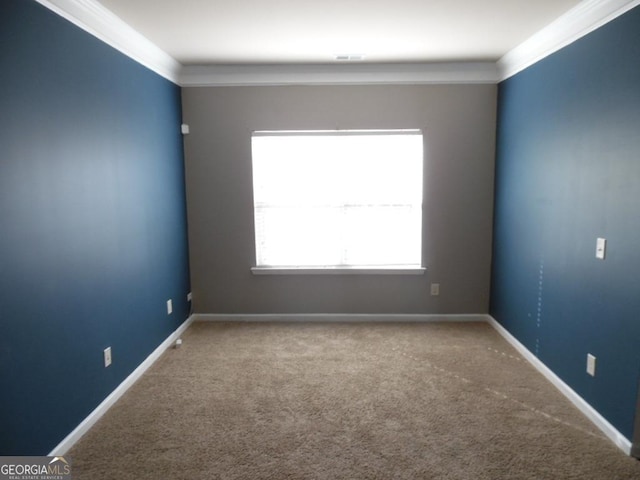 carpeted spare room with a healthy amount of sunlight and ornamental molding