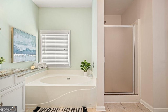 bathroom with plus walk in shower, vanity, and tile patterned flooring