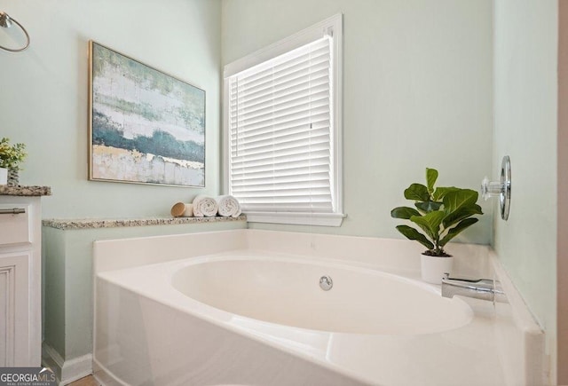 bathroom with a bathing tub and vanity