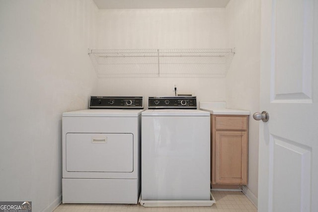 washroom with cabinets and independent washer and dryer