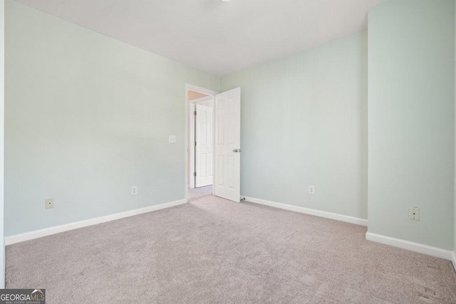 empty room featuring light carpet