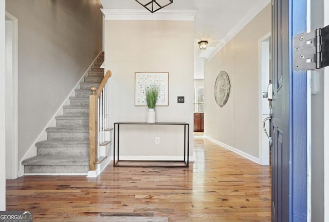 entrance foyer with crown molding and hardwood / wood-style flooring