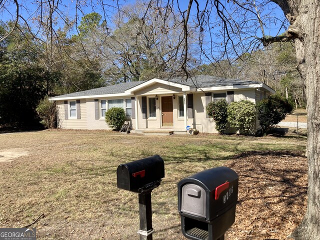 ranch-style home with a front yard