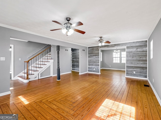 unfurnished living room with ceiling fan with notable chandelier, ornamental molding, and hardwood / wood-style flooring