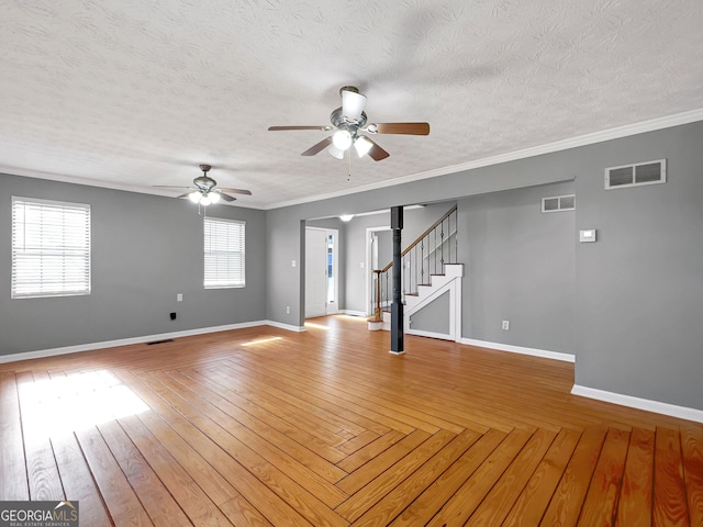 spare room featuring a textured ceiling, ceiling fan, crown molding, and light hardwood / wood-style floors