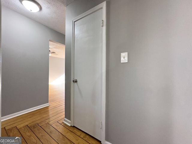 hallway with a textured ceiling