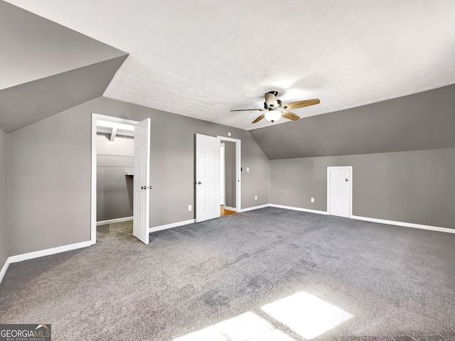 additional living space with a textured ceiling, ceiling fan, lofted ceiling, and carpet floors