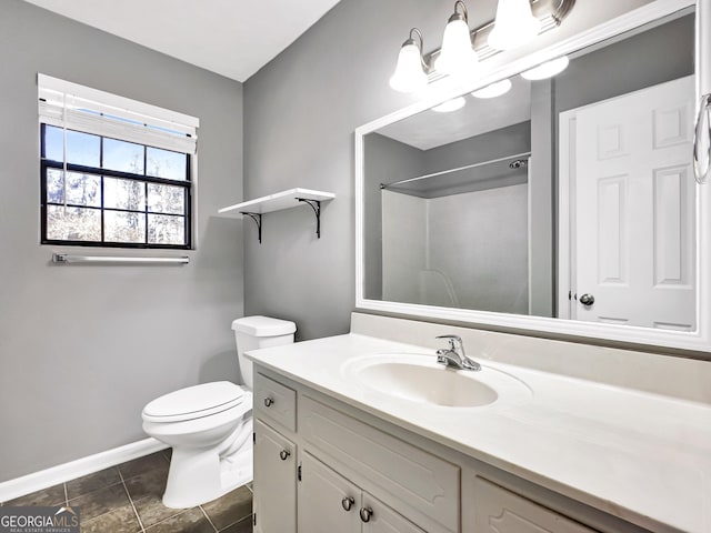 bathroom featuring toilet, tile patterned flooring, walk in shower, and vanity