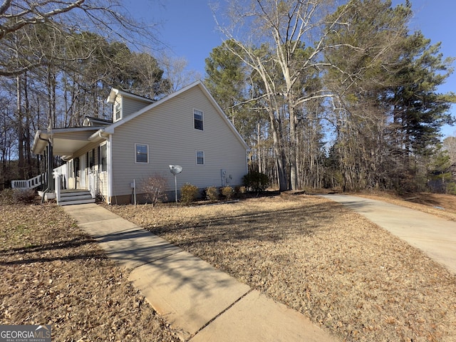 view of side of home with covered porch