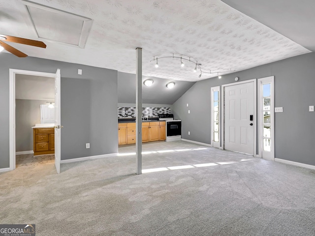 entrance foyer with ceiling fan, light carpet, a textured ceiling, and lofted ceiling