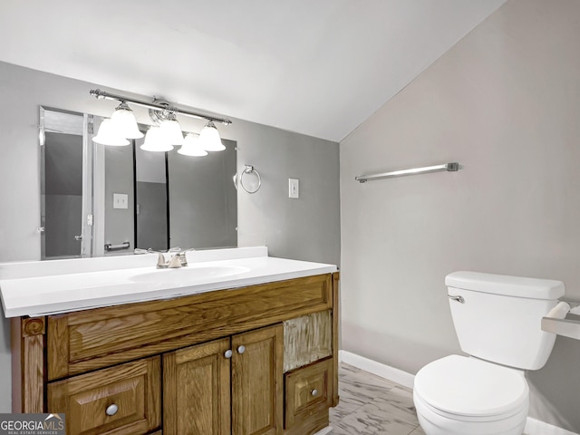 bathroom with toilet, vanity, and lofted ceiling