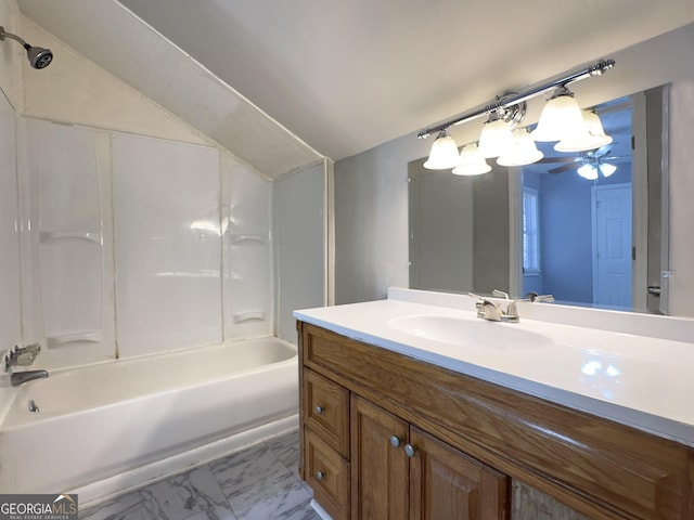 bathroom with lofted ceiling, shower / bathing tub combination, and vanity