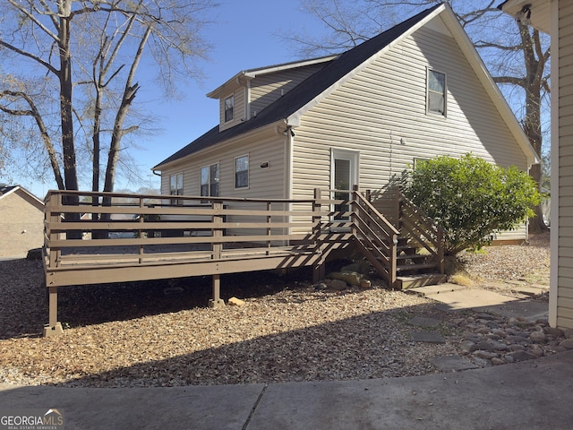 view of property exterior featuring a wooden deck