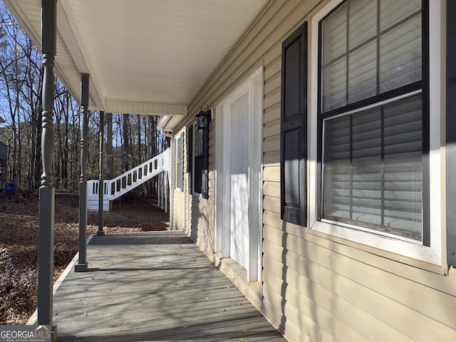 wooden terrace featuring covered porch