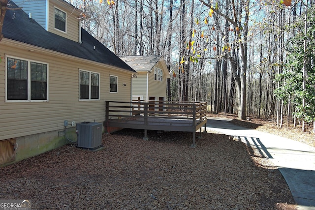 view of yard featuring central air condition unit and a wooden deck