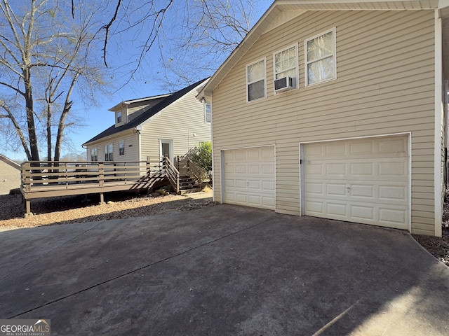 view of side of home with a wooden deck and a garage