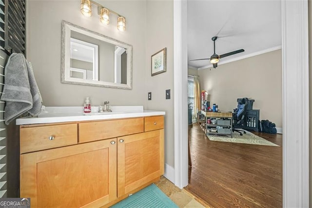 bathroom with vanity, ornamental molding, and ceiling fan