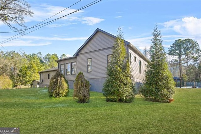 back of property featuring a yard and central AC unit