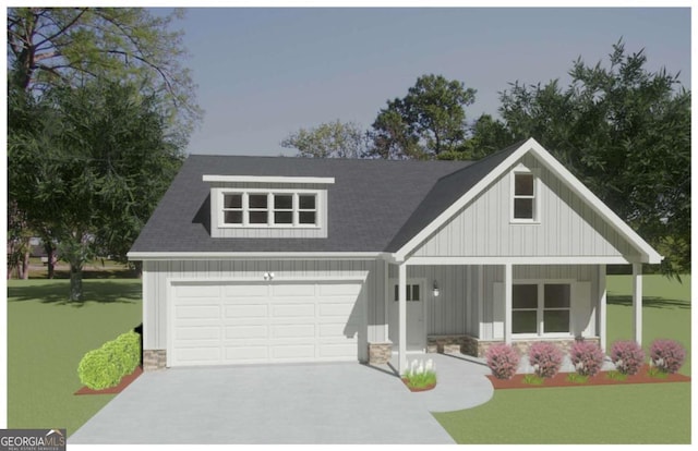 view of front facade with a garage, a front yard, and a porch