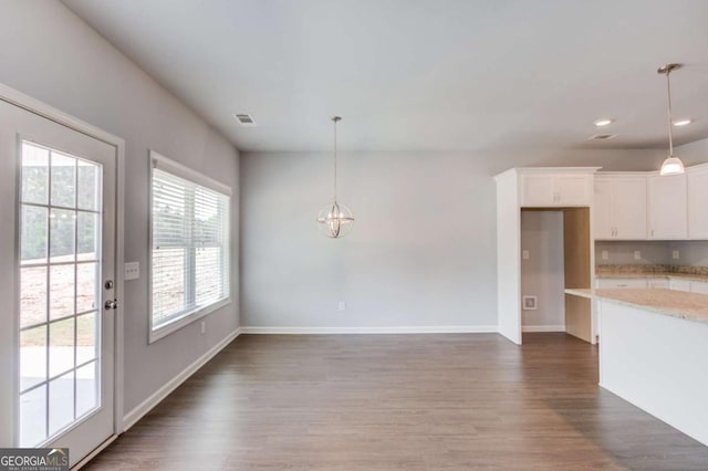 interior space with dark hardwood / wood-style flooring and a notable chandelier